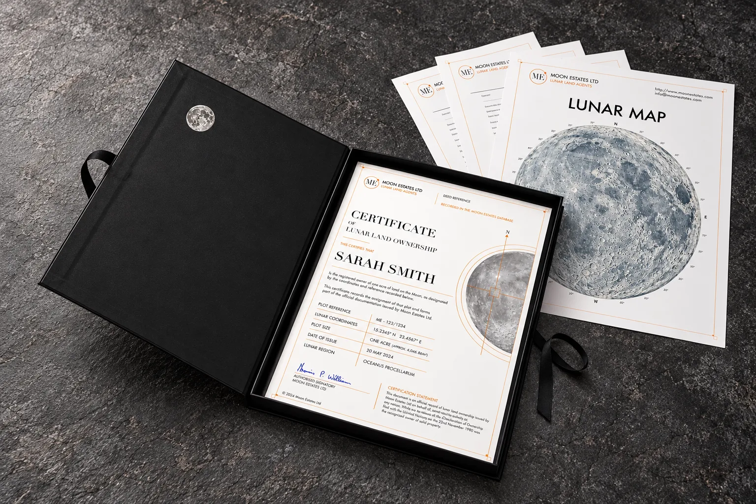 Moon Estates presentation gift box, opened to reveal a framed lunar land ownership certificate alongside a lunar map